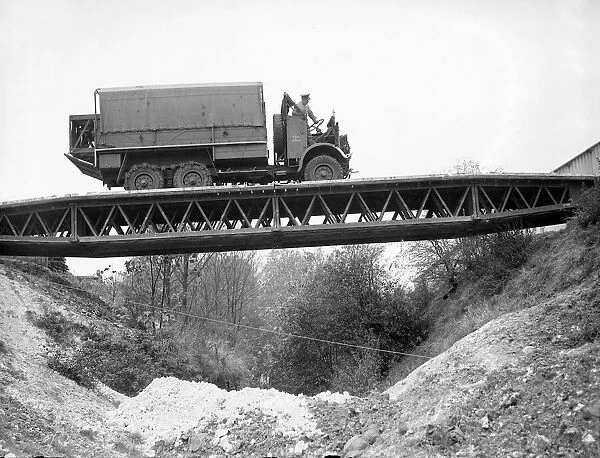 British army soldiers crossing over a bailey bridge in a truck during training exercises