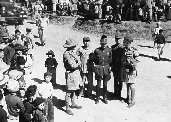 British and Chinese officers meet in a Burmese village during Second World War