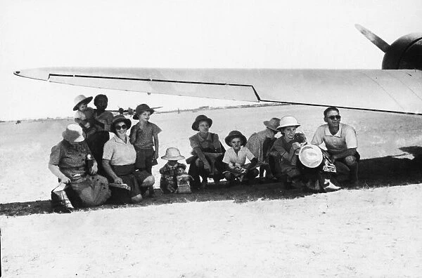 British civilians evacuated by RAF aircraft. Women and children shelter from the sun