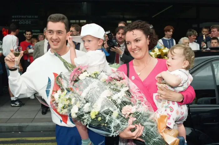 Framed Print : British cyclist Chris Boardman poses with his family on arrival at Manchester airport as Framed Print : British cyclist Chris Boardman poses with his family on arrival at Manchester airport as