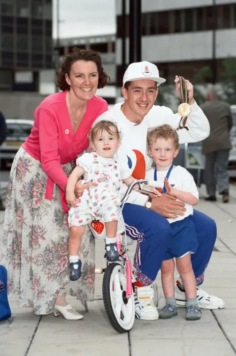 Framed Print : British cyclist Chris Boardman poses with his family on arrival at Manchester airport as Framed Print : British cyclist Chris Boardman poses with his family on arrival at Manchester airport as