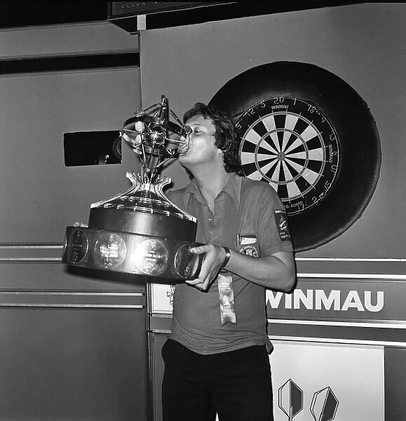 British dart player Eric Bristow holds aloft the trophy after winning the Worlds Masters