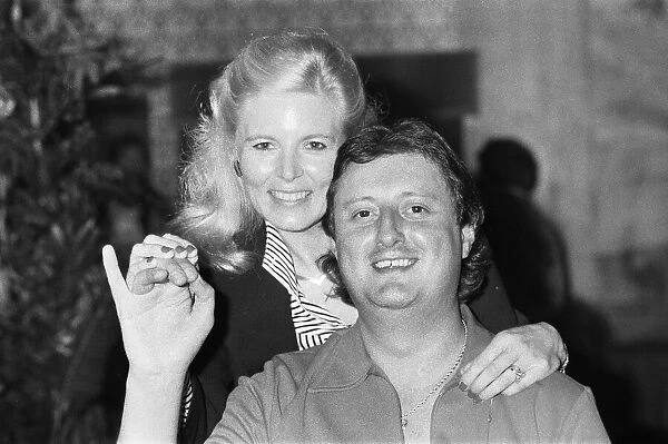 British dart player Eric Bristow poses with Maureen Flowers at the Embassy World