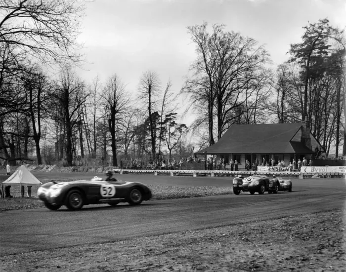 Framed Print : British Empire Trophy Race at Oulton Park. APR Rolt in a Jaguar leads J Framed Print : British Empire Trophy Race at Oulton Park. APR Rolt in a Jaguar leads J