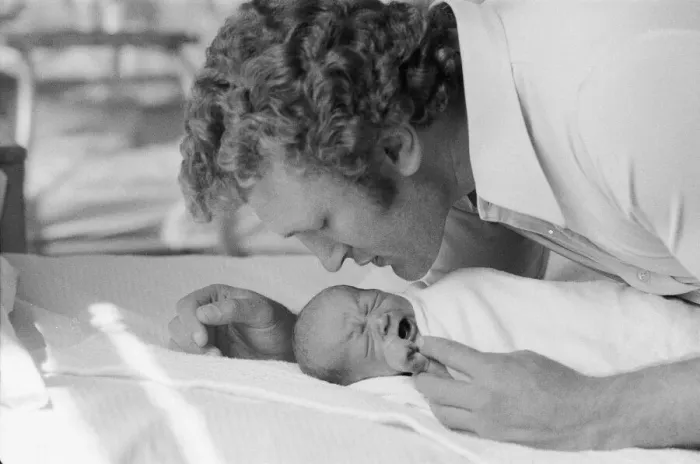 Framed Print : Former British European Heavyweight champion boxer Joe Bugner kisses his new born baby Framed Print : Former British European Heavyweight champion boxer Joe Bugner kisses his new born baby