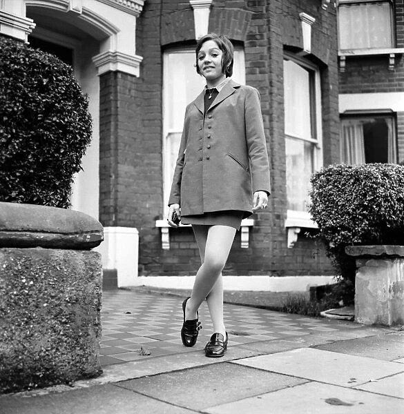 British family feature: Young teenage girl wearing school uniform walking down the street