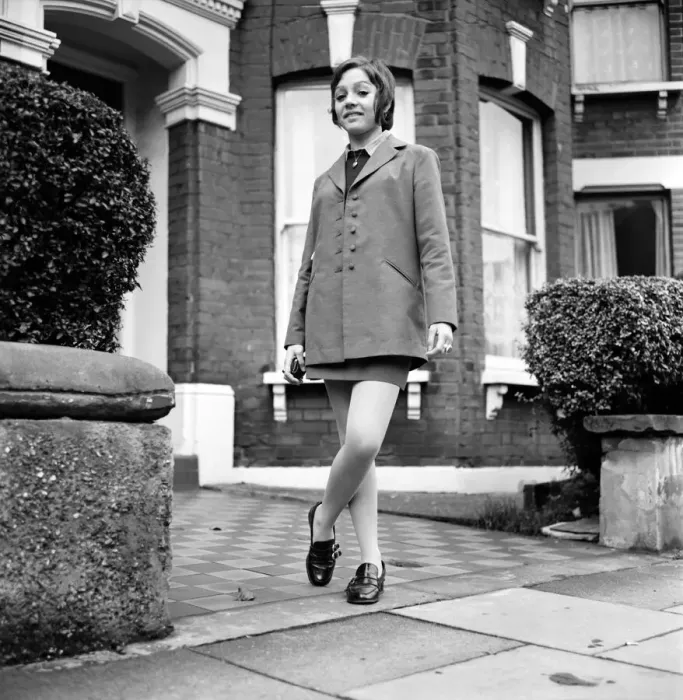 Framed Print : British family feature: Young teenage girl wearing school uniform walking down the street