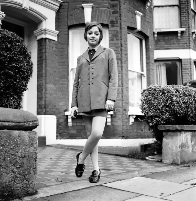 Framed Print : British family feature: Young teenage girl wearing school uniform walking down the street Framed Print : British family feature: Young teenage girl wearing school uniform walking down the street