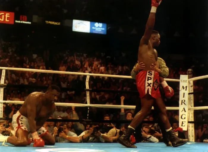 Framed Print : British Heavyweight champion iLennox Lewis raises his arm in celebration after knocking