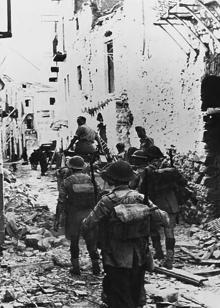 British infantry move through Centuripe in Sicily. 17th August 1943