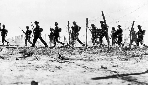 British infantry making their wat through a gap in the barbed wire defences during