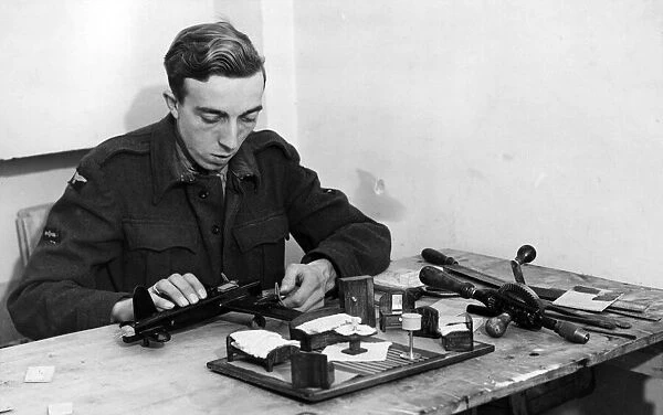 A British LAC enjoying spare time with a model aircraft kit. 7th December 1944