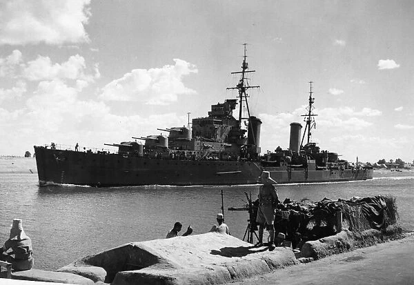 The British Light Cruiser HMS Euryalus passing an Egyptian mine spotting post on the Suez