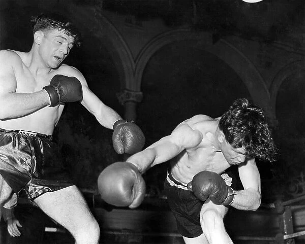 British middleweight boxer Johnny Sullivan catches Michael Stack with a left swing