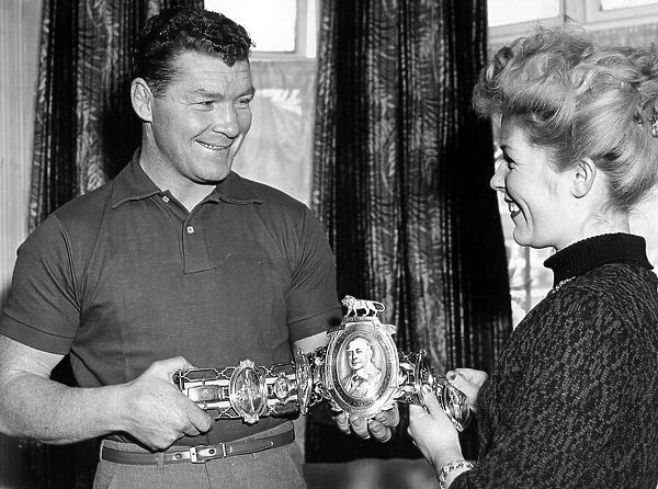 British middleweight champion Mick Leahy hands over his Lonsdale Belt to his wife