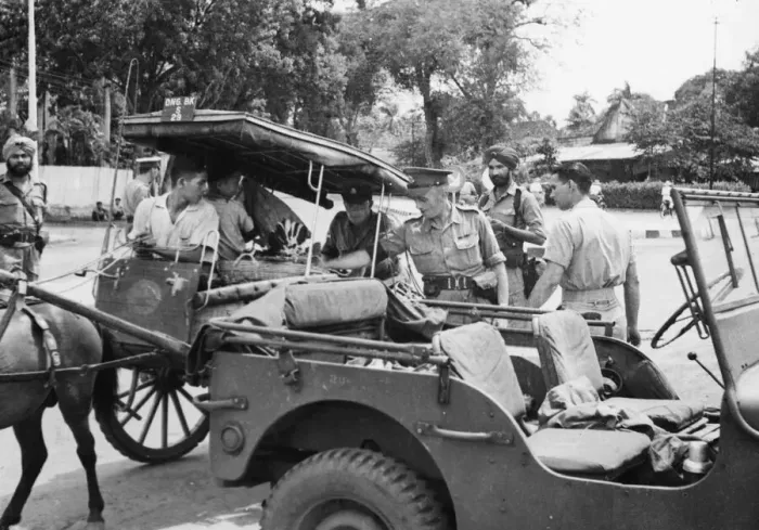 Framed Print : British Military Policemen search an Indonesian cart. Onlookers are Indian Military