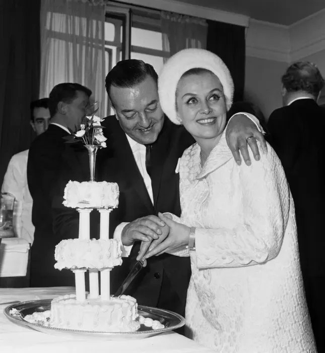 Framed Print : British musician Ronnie Ronalde cuts the cake with his new bride Yana after their wedding