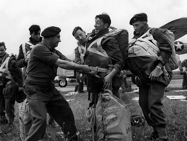 British Paratroops Army Soldiers August 1952 An officer tightens a chute for a