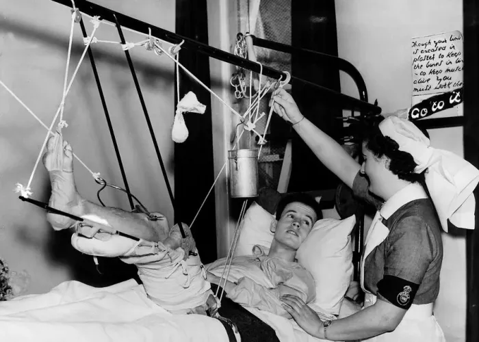 Framed Print : British pilot with a fractured thigh talks to a nurse from his hospital bed Framed Print : British pilot with a fractured thigh talks to a nurse from his hospital bed