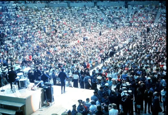 Framed Print : British pop group The Beatles playing to a huge crowd out a packed out music venue during Framed Print : British pop group The Beatles playing to a huge crowd out a packed out music venue during