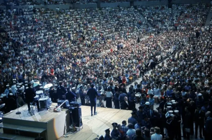 Framed Print : British pop group The Beatles playing to a huge crowd out a packed out music venue during Framed Print : British pop group The Beatles playing to a huge crowd out a packed out music venue during