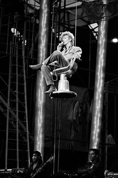 British pop singer David Bowie pictured performing on stage at Wembley Stadium during his