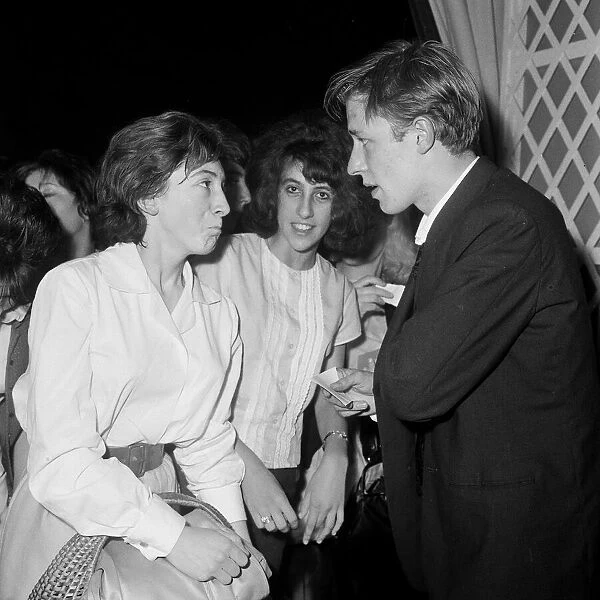 British pop singer Mike Sarne with female fans. 12th September 1962