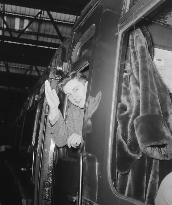 Framed Print : British pop singer Terry Dene waving from the train carriage window as he leaves for Framed Print : British pop singer Terry Dene waving from the train carriage window as he leaves for