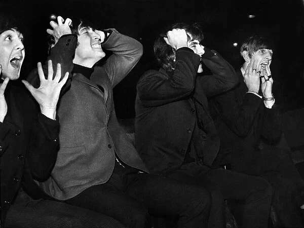 British pop stars The Beatles mimicking their screaming fans as they pose before their