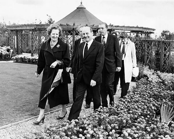 British Prime Minister Margaret Thatcher is led by Sir Leslie Young through the Victorian