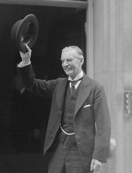 British Prime Minister Neville Chamberlain acknowledges the cheers of the crowd on his