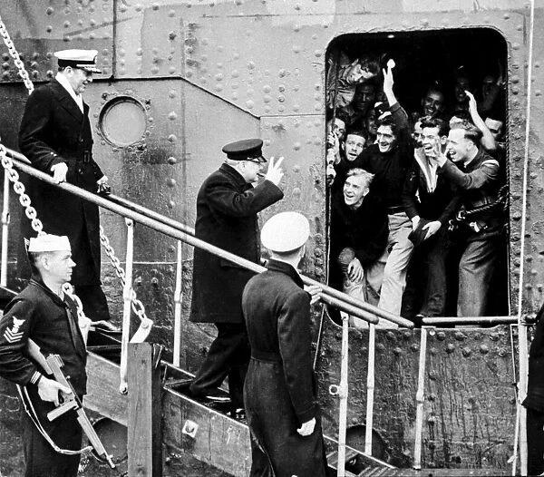British Prime MInister Winston Churchill gives the V sign to sailors as he disembarks his