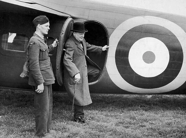 British Prime minister Winston Churchill leaves his aeroplane for a visit to a defence