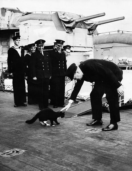 British Prime Minister Winston Churchill onboard HMS Prince of Wales - stroking a black