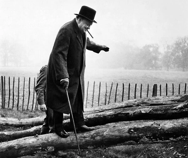 British Prime Minister Winston Churchill walking up one of the greasy inclined logs used