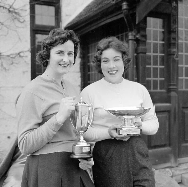 British racing drivers Pat Moss and Ann Wisdom celebrate with the Ladies Cup trophy after