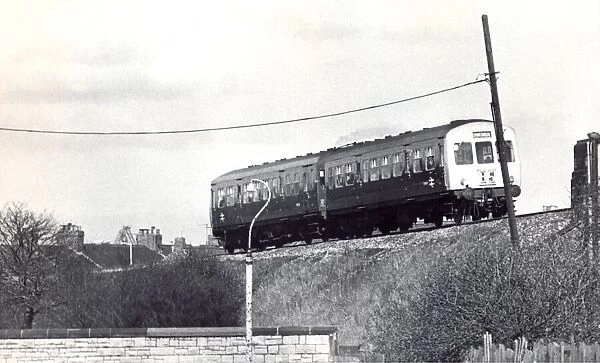 A British Rail diesel train roars along the track near Tyne Dock Station