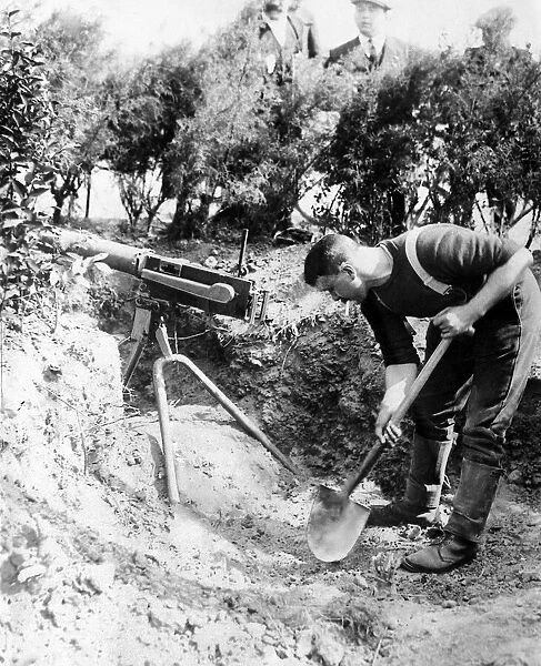 A British Royal Marine seen here digging in a machine gun emplacement close to