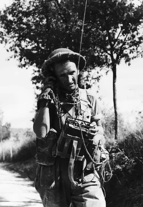 Framed Print : British signalman operating his No. 38 set as he walks along a road during WW2 Framed Print : British signalman operating his No. 38 set as he walks along a road during WW2