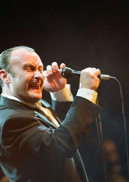 British singer Phil Collins performing on stage during a concert in Britain