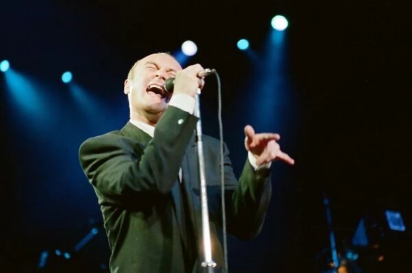 British singer Phil Collins performing on stage during a concert in Britain