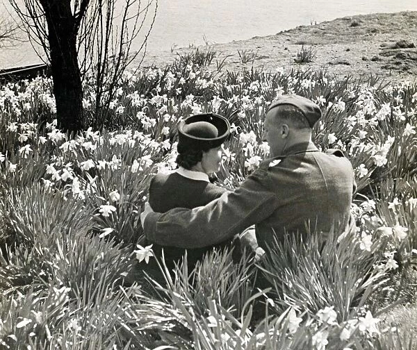British soldier on leave and his girl sitting amongst the daffodils in Kensington Gardens