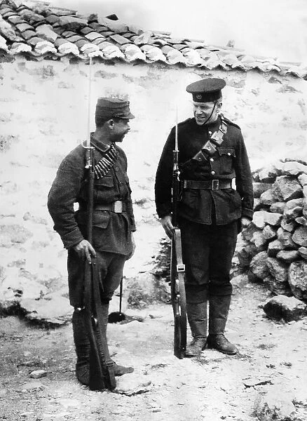 British soldier shows an interested Greek soldier the English way to mount guard