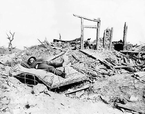 British soldier taking nap on bed found amid the ruins of a French house 1916