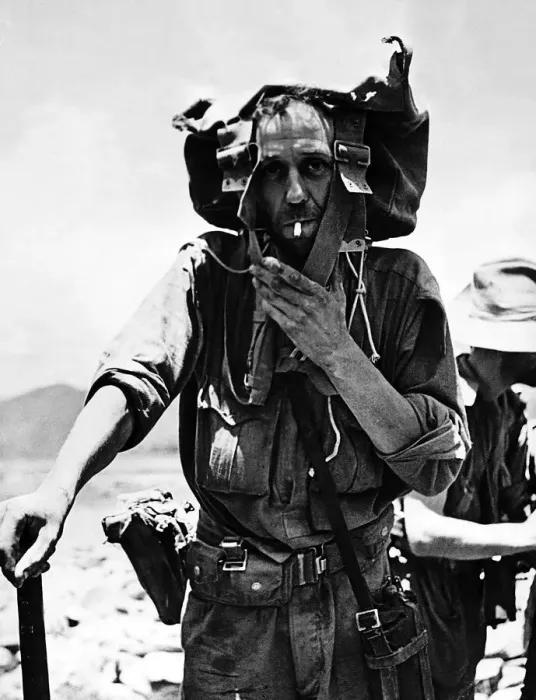 Framed Print : A British soldier uses his backpack to shade his head from the sun as he returns to India Framed Print : A British soldier uses his backpack to shade his head from the sun as he returns to India