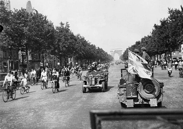 British soldiers drive a car carrying the the Union Jack flag down the Champs Elysee