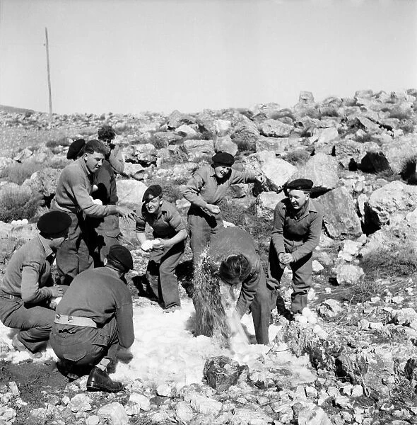 British soldiers on the way back from Wadi Pouse stop for a snowfall fight in Jordan