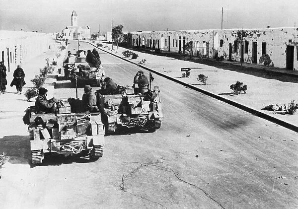 British tanks make their way through a town in Algeria during the Second World War