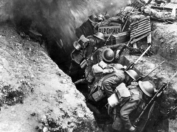 British troops cower as a shell bursts on the parapet of their trench '