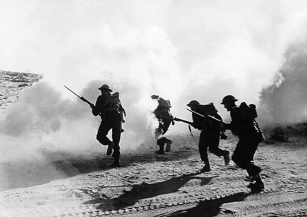 British troops with fixed bayonets advance through a smoke screen in the Western Desert